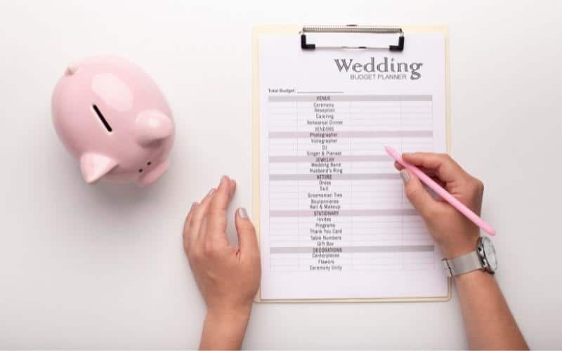 Woman-writing-wedding-expenses